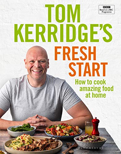 "Cookbook cover featuring Tom Kerridge with a table of prepared dishes."