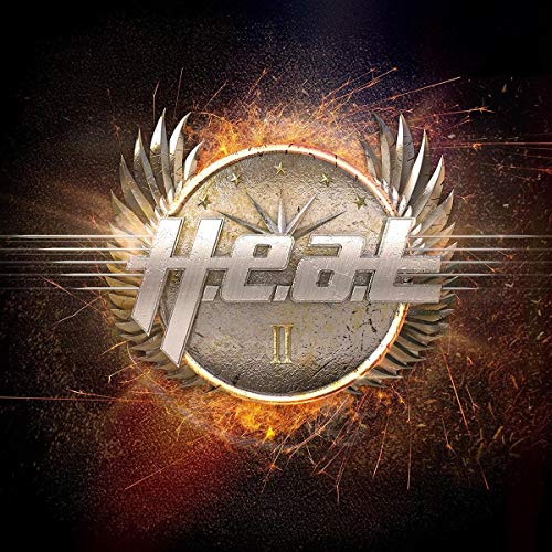 The image depicts a vinyl record cover for the album "H.E.A.T II". The cover features a metallic silver logo with the band's name, surrounded by a circle of sparks and flames. The text "H.E.A.T" is written in large, stylized letters, with the Roman numeral "II" below it. The background is black, with sparks and flames radiating from the center of the image. Alt text: Silver logo with "H.E.A.T II" surrounded by