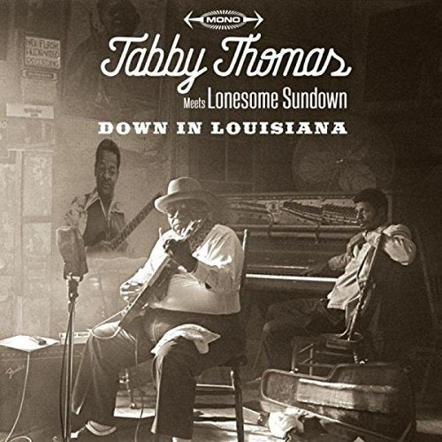 "CD cover featuring three musicians in a dimly lit room, sepia-toned image."