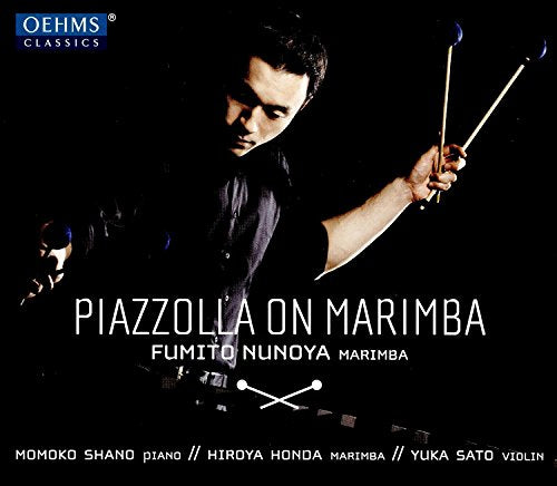 Man playing marimba with mallets, against a black background, with white text overlay.