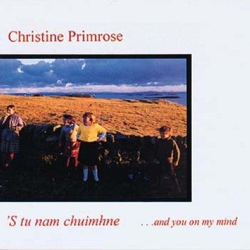 Album cover with four children standing by a stone wall, outdoors.