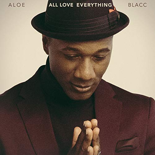 "Man in a fedora and suit, praying, on a vinyl album cover."