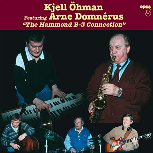 "Album cover featuring four musicians playing various instruments against a dark background."