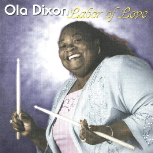 "CD cover with a smiling woman holding drumsticks, wearing a light jacket."