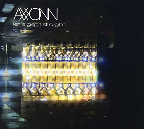"CD album cover with a lit-up building at night, artist name and title."