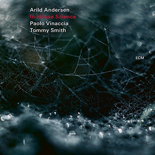 The image shows a CD cover with a dark, icy background and white text. The alt text is: "CD cover with icy background, cracked ice, and artist names in white text."