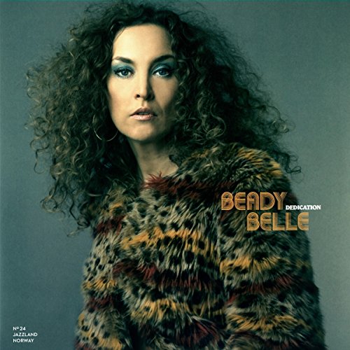 "Album cover featuring a woman with curly hair wearing a leopard-print coat."
