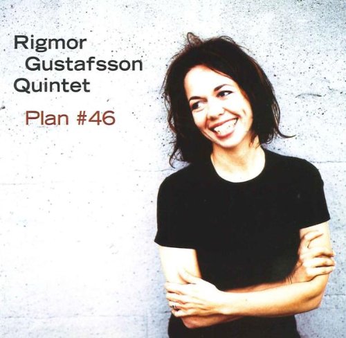 Album cover featuring a smiling woman in a black shirt against a grey wall.