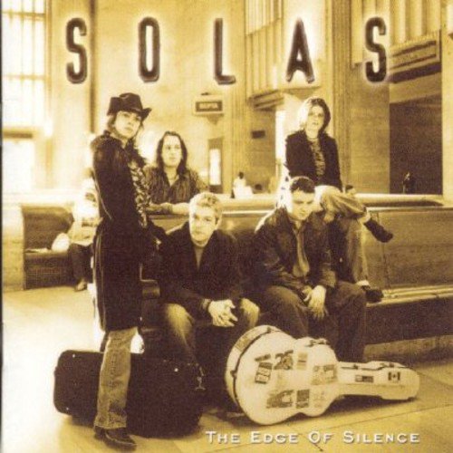 "CD cover featuring a sepia-toned image of the band Solas in a train station."