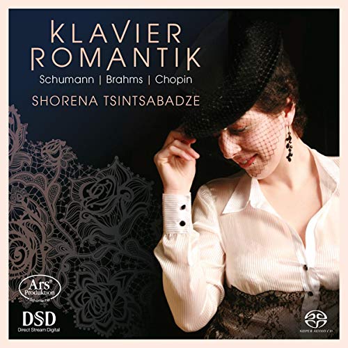CD cover featuring a woman in a white shirt and black hat, dark background.
