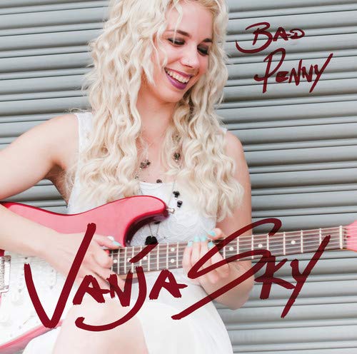 The image depicts a blonde woman holding a red and white electric guitar.