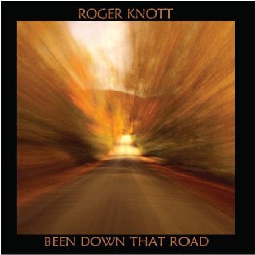 Album cover with a blurred road and orange hues, surrounded by a black border.