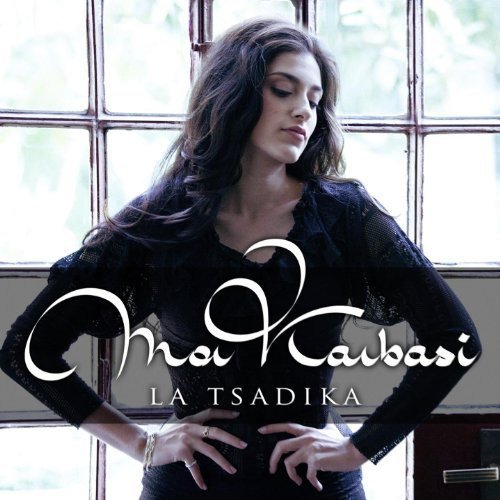"CD cover featuring a woman in black standing in front of a grid window."