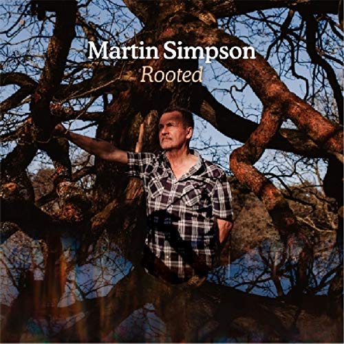 "Album cover featuring a man in plaid shirt standing in a large tree."