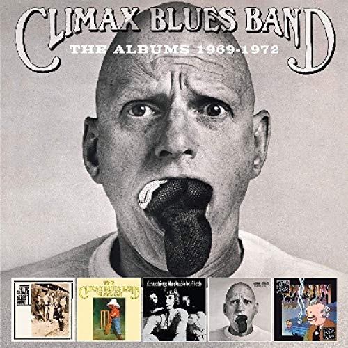 "CDs and album covers featuring a man's face, scattered on a white background."