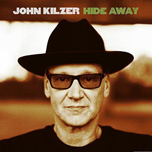 Album cover featuring a man in a black hat and sunglasses with artist's name.