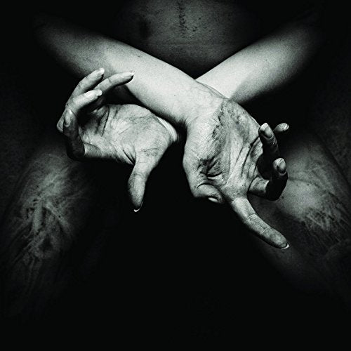 Black and white image of two hands crossed over a person's bare chest.
