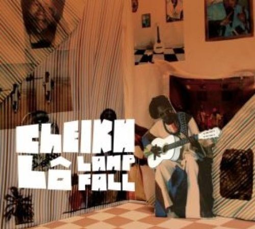 "Album cover: man playing guitar in a room with checkered floor and striped curtains."