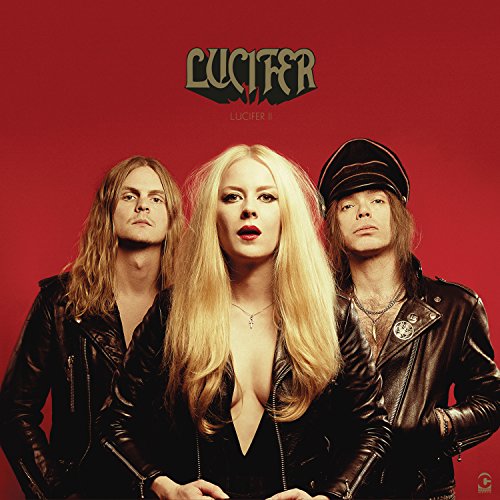 "Album cover featuring three people in black leather jackets against a red background."