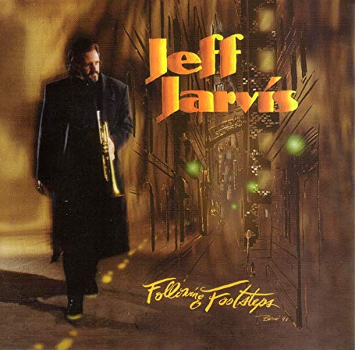 "Album cover featuring a man in black holding a trumpet on a city street."