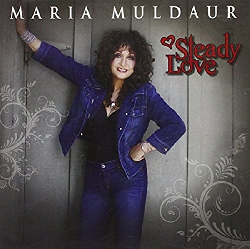 Maria Muldaur posing against a gray wall on the album cover "Steady Love".