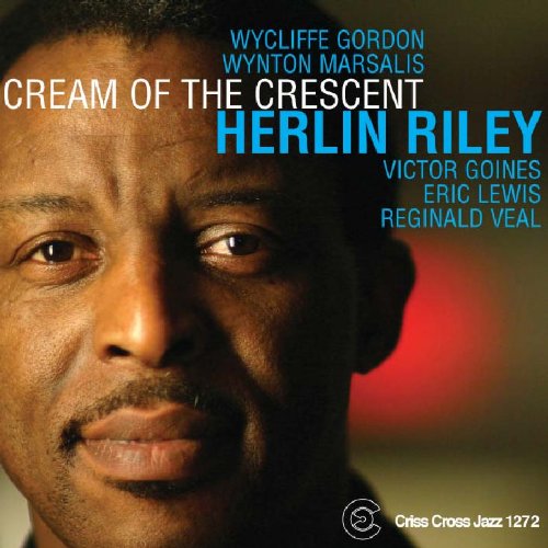 Album cover with close-up of man's face and artist names in blue and white text.