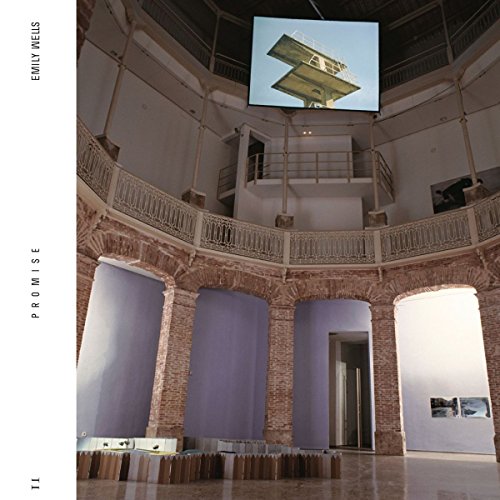 "Album cover featuring a photograph of a large, circular, white, and brick room."
