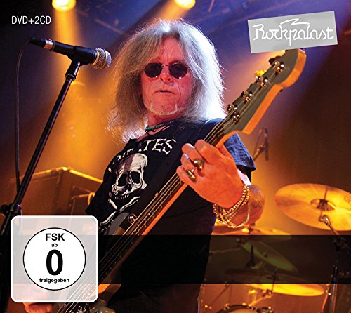 CD cover featuring a man playing bass guitar on a lit stage.