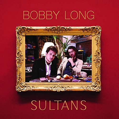 "Album cover: two men at a table, in a gold frame, on red background."