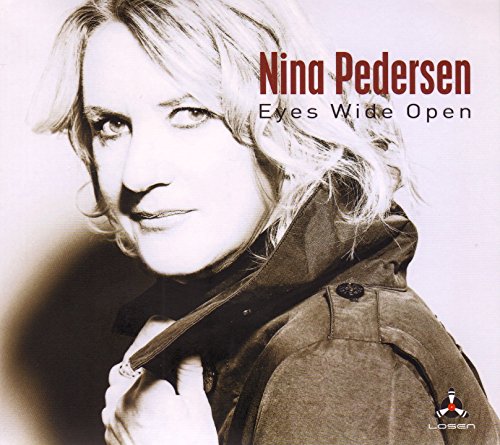 Album cover featuring a woman with blonde hair, wearing a jacket, with artist and album name.