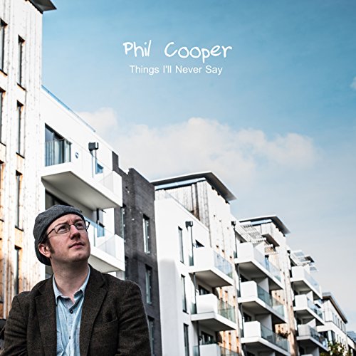 The alt text for the image is: "Album cover with man standing in front of modern buildings."