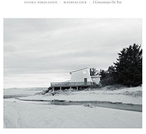 "Vinyl record cover featuring a black and white photo of a beach house."