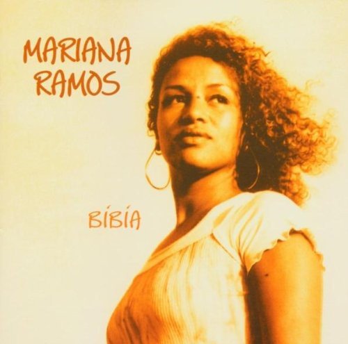 Album cover featuring a woman with curly hair and a white top against a beige background.