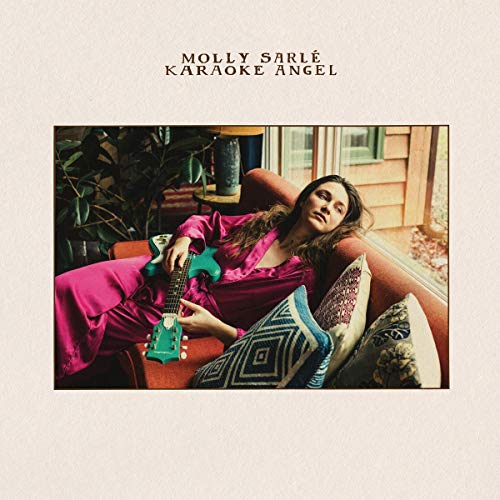 Album cover featuring a woman in pink lounging on a couch with a ukulele.