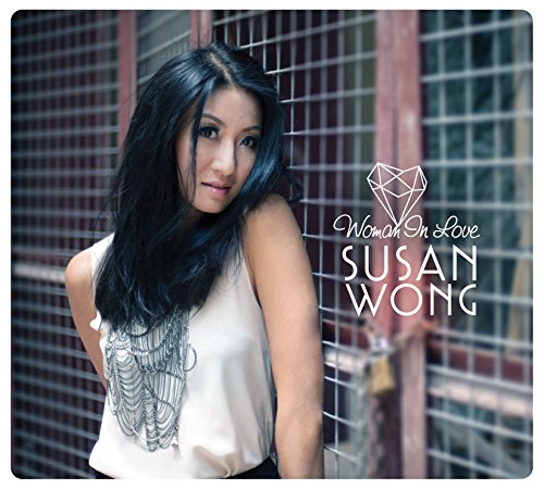 The image is a CD cover featuring a woman with long black hair wearing a white sleeveless top.