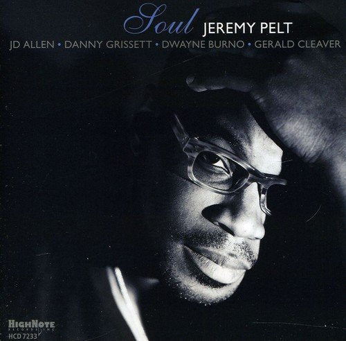 Album cover with a black-and-white photo of a man wearing glasses.