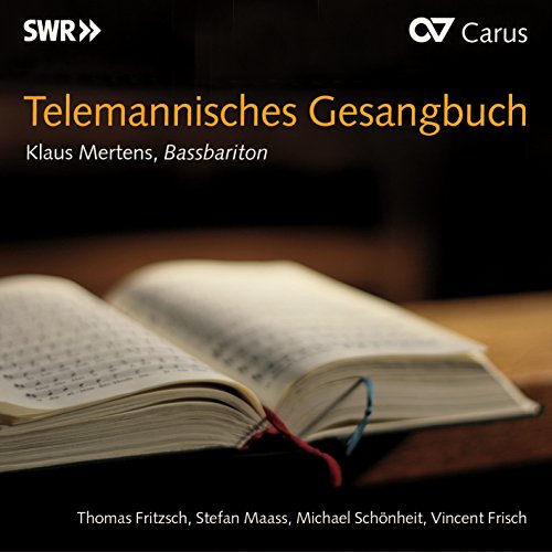 "An open book with sheet music, on a dark wooden surface, with text overlay."