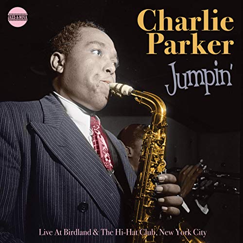 "Album cover featuring Charlie Parker playing saxophone, wearing a suit and red tie."