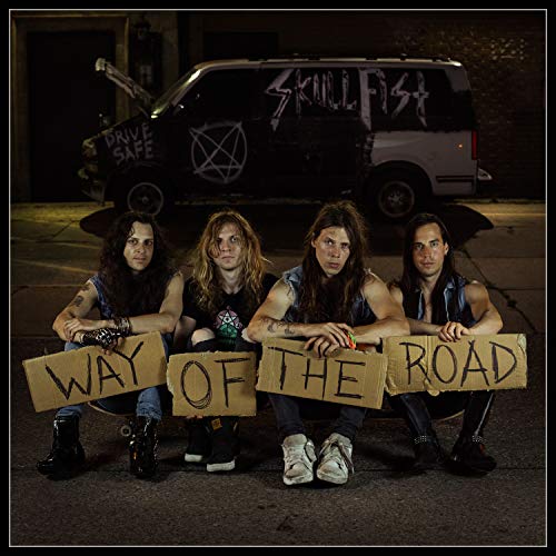 "Four men kneeling behind cardboard signs that read 'WAY OF THE ROAD' at night."