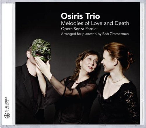 CD cover with man and two women in black, man's face obscured by floral mask.