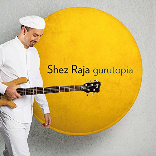 Man in white clothing plays a light-brown guitar beside a large yellow circle.