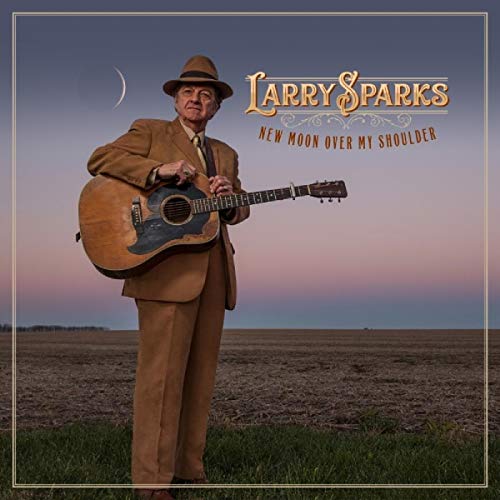 Album cover featuring a man in a brown suit holding a guitar outdoors.