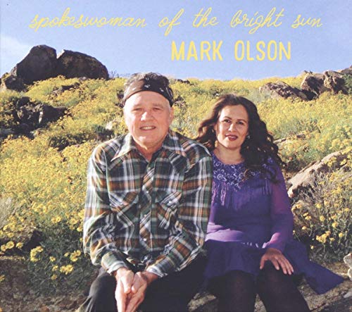 "Album cover with a man and woman sitting together in a field of yellow flowers."