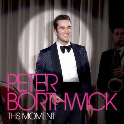 "Album cover featuring a man in a tuxedo with a trumpet player beside him."