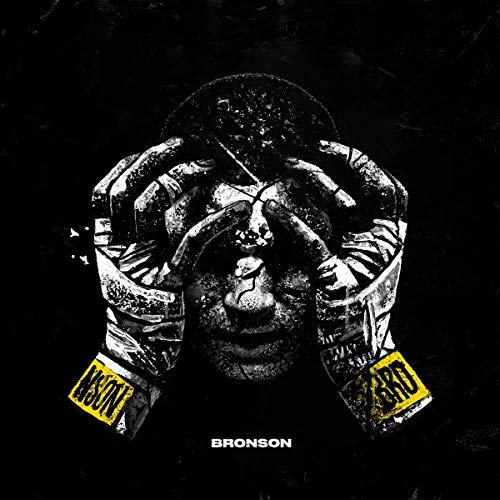 A black-and-white image of a man's face with yellow labels, titled "Bronson".