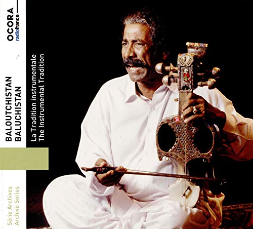 Man in white holds a traditional stringed instrument, sitting cross-legged against a dark background.