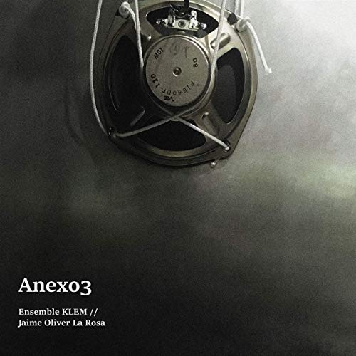 "Album cover featuring a silver metal speaker against a dark, smoky background."
