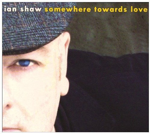 Album cover featuring a man wearing a hat, with artist and album name.