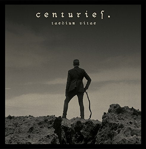 "Black and white vinyl album cover with man standing on rocky terrain."