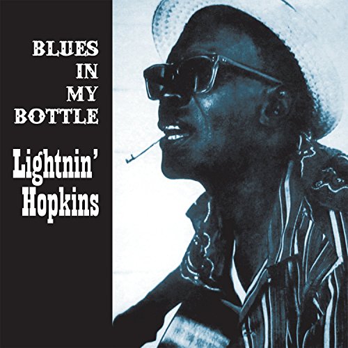 "CD cover with black and white image of man wearing hat, sunglasses, and smoking."